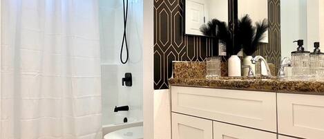 A bathroom with a shower curtain, a toilet, a sink with a mirror, and a patterned wall.