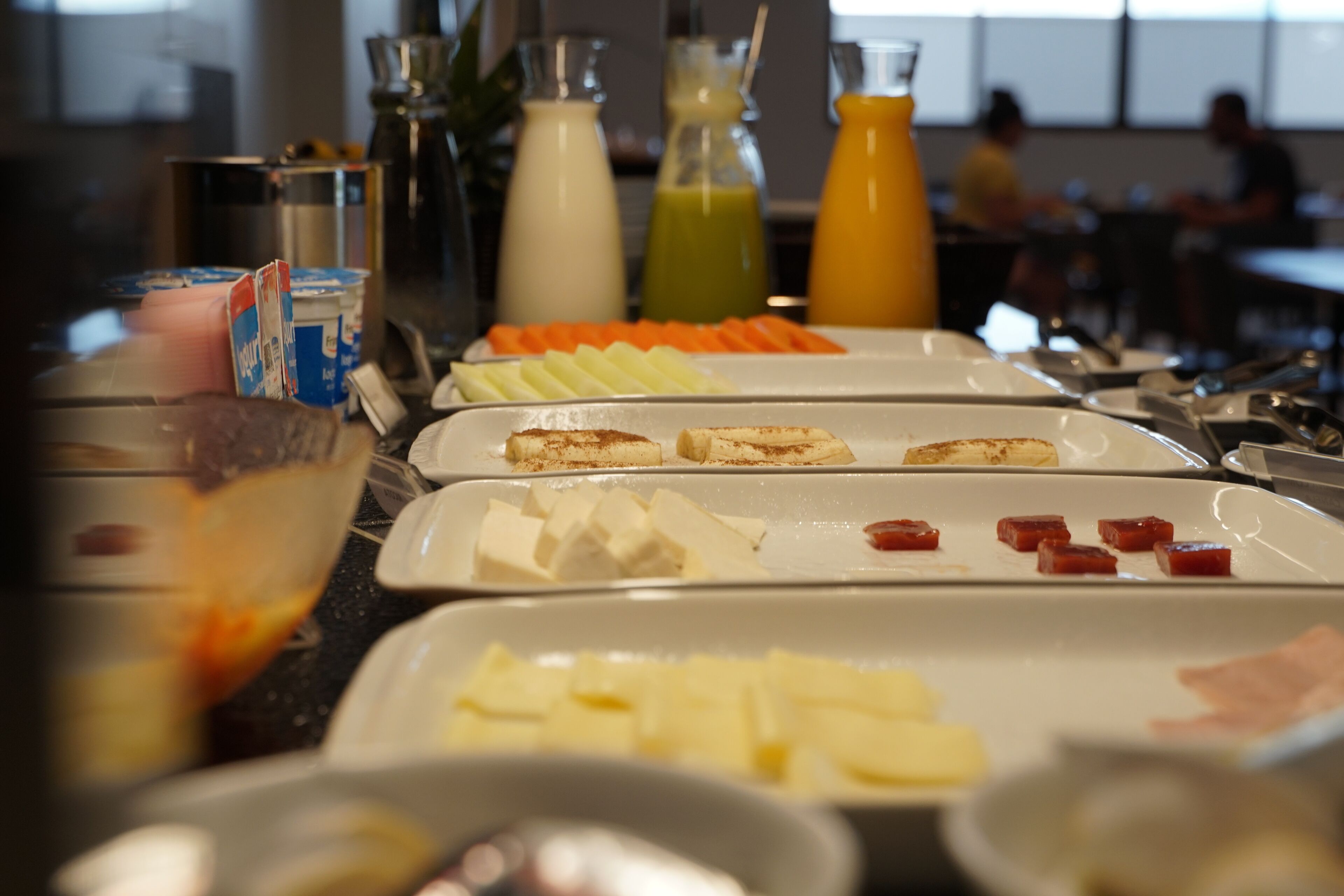 A buffet with various food items and beverages.