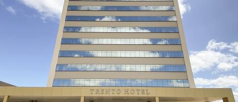 A multi-story hotel with a modern facade, large windows, and a prominent entrance.