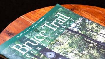 A book titled "Bruce Trail" on a wooden surface.