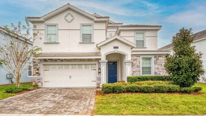 A two-story house with a garage, a front door, and a small porch.
