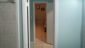 A bathroom with a shower, a toilet, and a sink. - Private bedroom w/AC & Heating + Bathroom (Tampa)