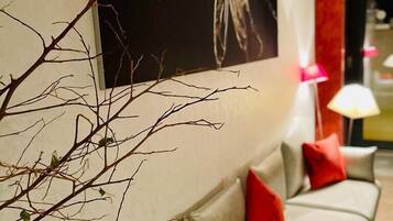 Relax in a clean, minimalist space with a long sofa and a statement artwork.