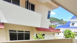 A multi-story building with a flat roof, large windows, and a balcony. - MUTIARA HEIGHT HOMESTAY  (Bentong)