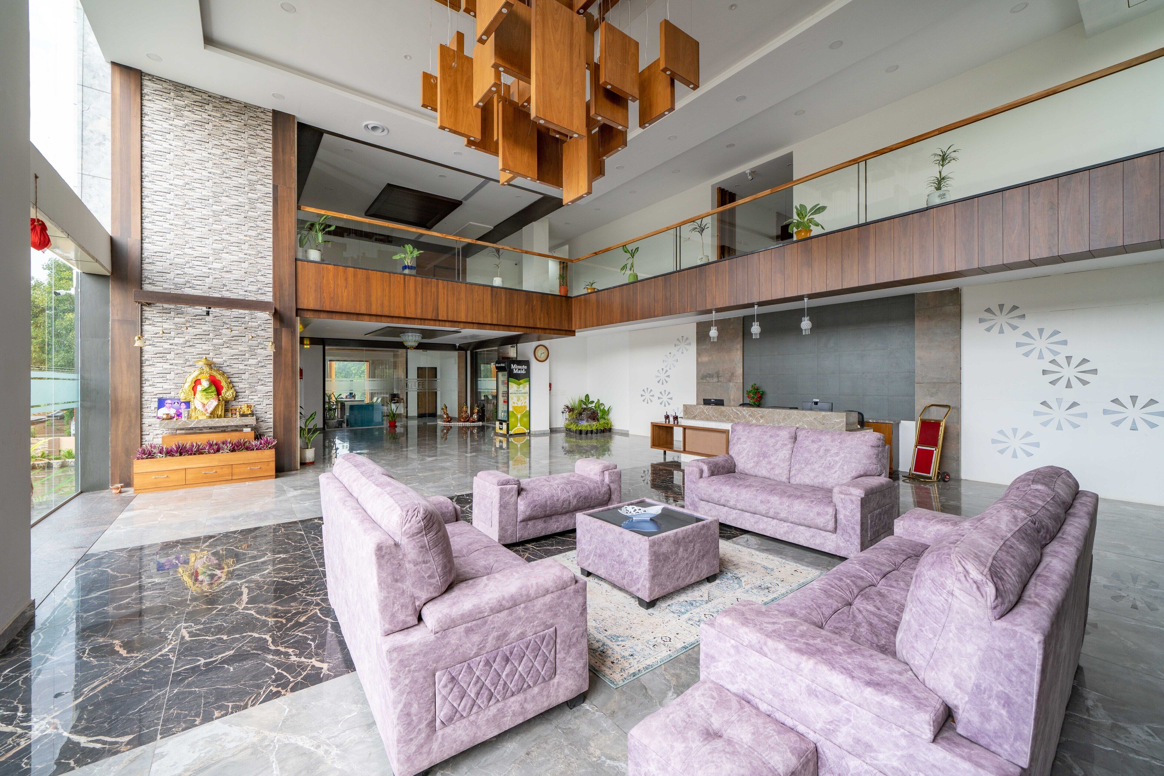 A spacious lobby with plush seating, a stone accent wall, and a modern chandelier.
