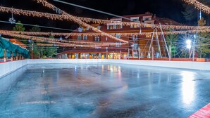 Eine Eishalle mit einem Gebäude im Hintergrund.
