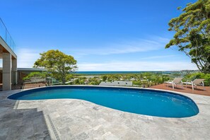 Relax by the pool with ocean views and lounge on the deck.