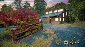 A modern house with a gravel driveway and a wooden fence. - Woodland Retreat (#97B) | Quiet area | Minutes to Bryce Resort! (Basye)