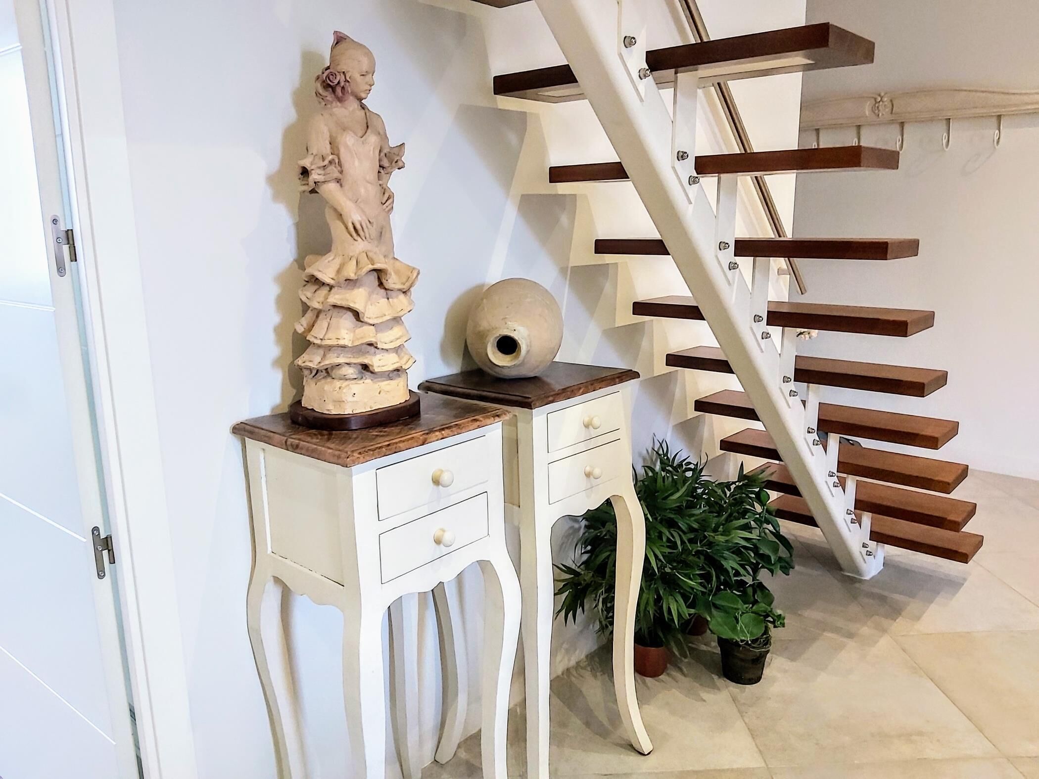 A staircase with wooden steps and a white wall.