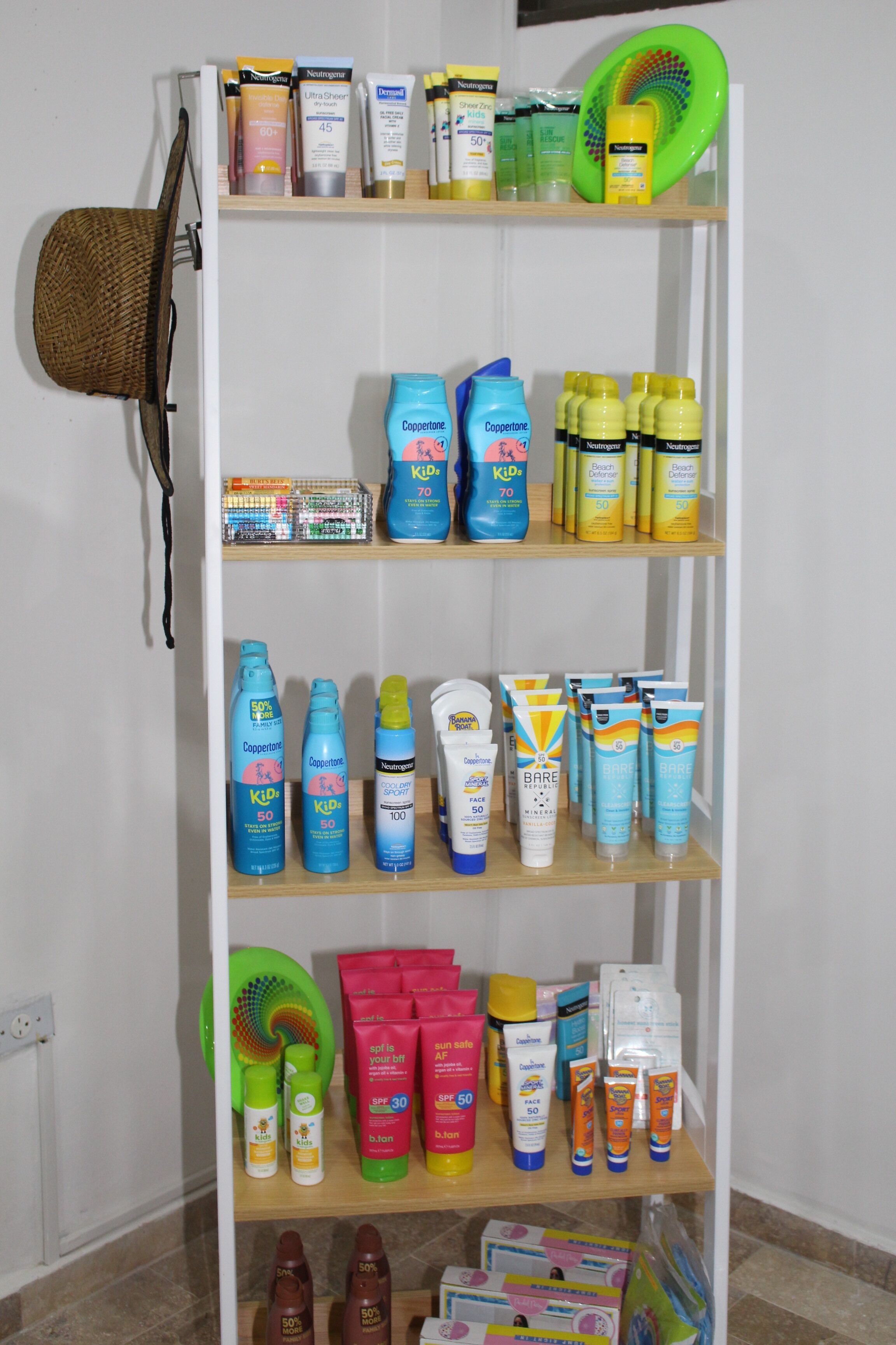 A shelf stocked with various personal care products including shampoos, conditioners, and lotions.