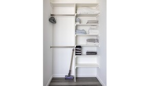 A white closet with shelves for folded clothes and a hanging rod for shoes. - NEWLY RENOVATED BUNGALOW WITH FREE PARKING ON SITE (Los Angeles)