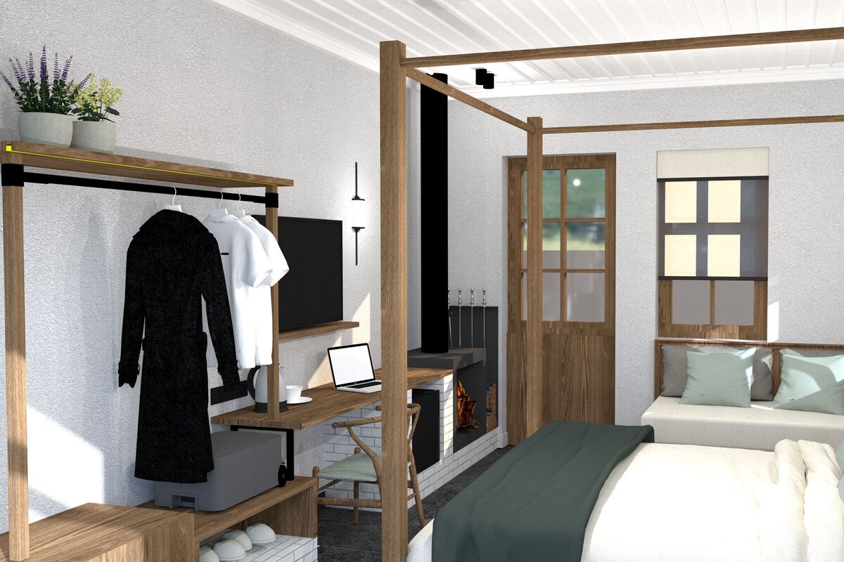Un dormitorio con cama con dosel, un escritorio con computadora portátil, un armario y una ventana.