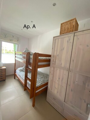 Cozy room with a bunk bed, wardrobe, and natural light.