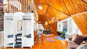 A cozy attic-style room with wooden floors, a dining area, and a lofted seating area with a staircase. - Unique Dome with HotTub & Mtn Views (Bryant Pond)
