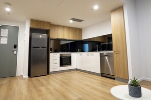 Enjoy cooking in this well-equipped kitchen with a stainless steel refrigerator, oven, and dishwasher.