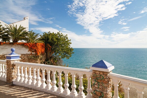 Enjoy breathtaking views of the clear blue sea from this balcony overlooking the ocean.