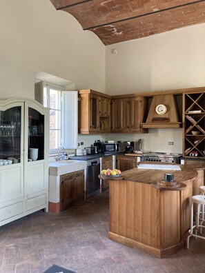 Enjoy cooking in this well-equipped kitchen with a central island, stove, and ample storage.