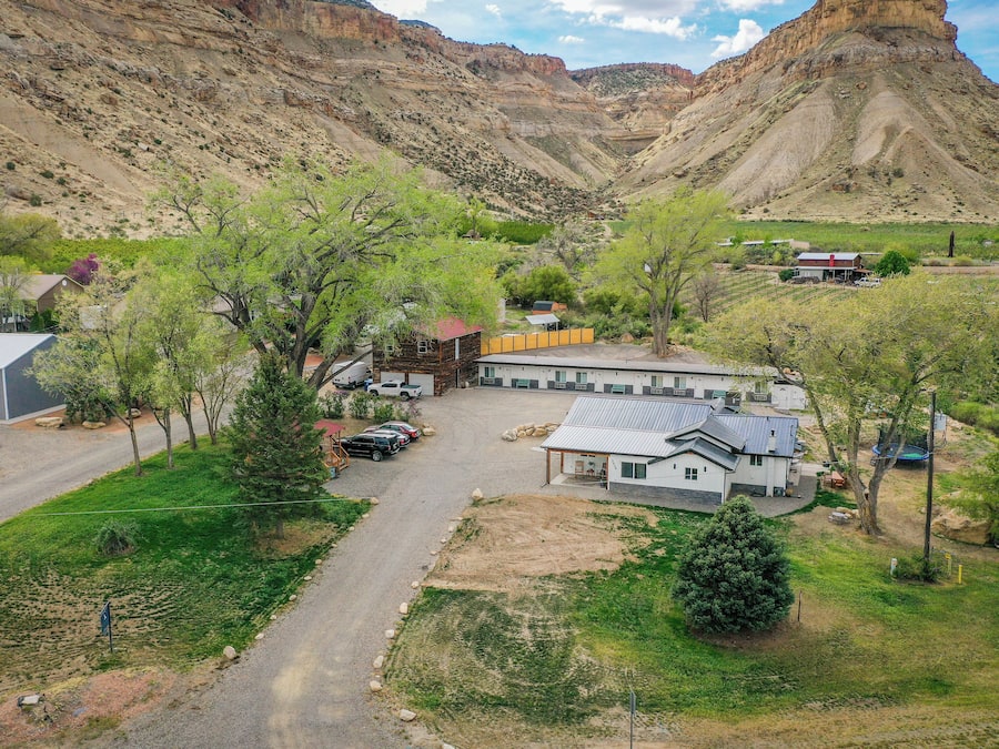 A residential area with houses, a road, and a mountainous backdrop.