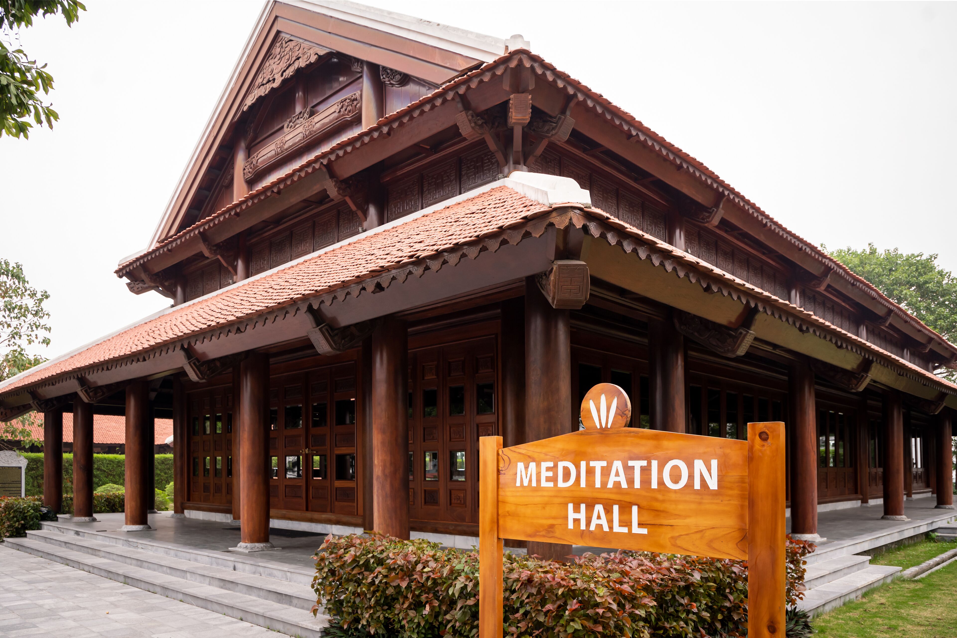 A wooden building with a sign reading "Meditation Hall".