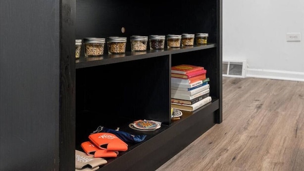 Una estantería con frascos y libros.
