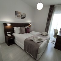 Superior Room | Minibar, in-room safe, blackout drapes, iron/ironing board