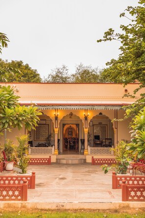 A traditional building with a central entrance, flanked by two symmetrical arches and a series of columns. - Shahpura Abhaneri Resort (Baswa)