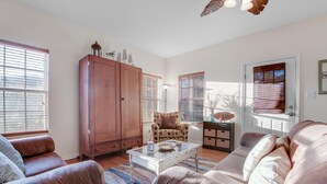 A living room with leather sofas, a wooden cabinet, and a coffee table.