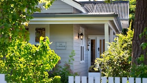 A house with a porch, a sign reading "The Homestead," and a white picket fence. - Homestead - Picturesque home in an ideal location (Hepburn Springs)
