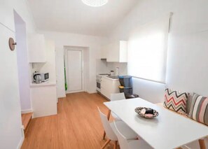 A compact kitchen with a microwave, a small oven, and a sink.