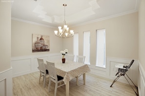 Enjoy meals in this dining area with a round table and comfortable seating for four.