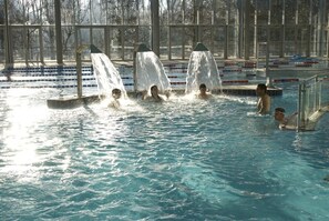 A swimming pool with multiple lanes and a water slide. - Le Géant, Privilège (sleeps 6) - Nantes Camping***** (Nantes)