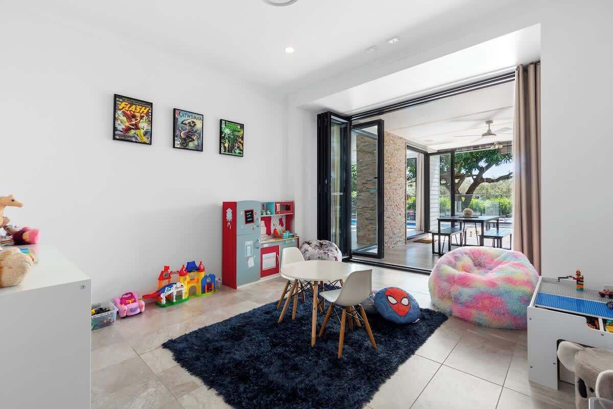 A modern living room with a dining area, a large window, and a view of the outdoors.