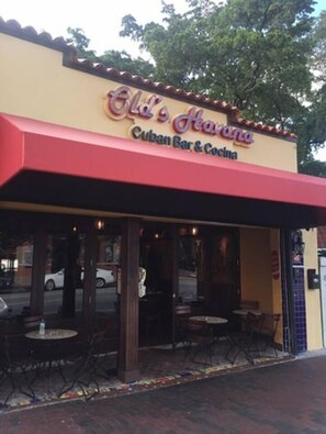 A restaurant named 'Old Havana Cuban Bar & Cocina' with outdoor seating and a red awning. - Authentic Little Havana • Walk to Calle Ocho (Miami)