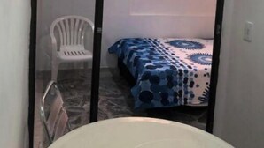 A room with a bed, a chair, and a window. - Comfortable, central and well located apartment - Apt 201 (Medellín)