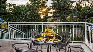 A deck with wicker chairs and a table set for a meal, surrounded by a white railing. - Vacation apartment right by the sea-50 m from the beach (Fažana)