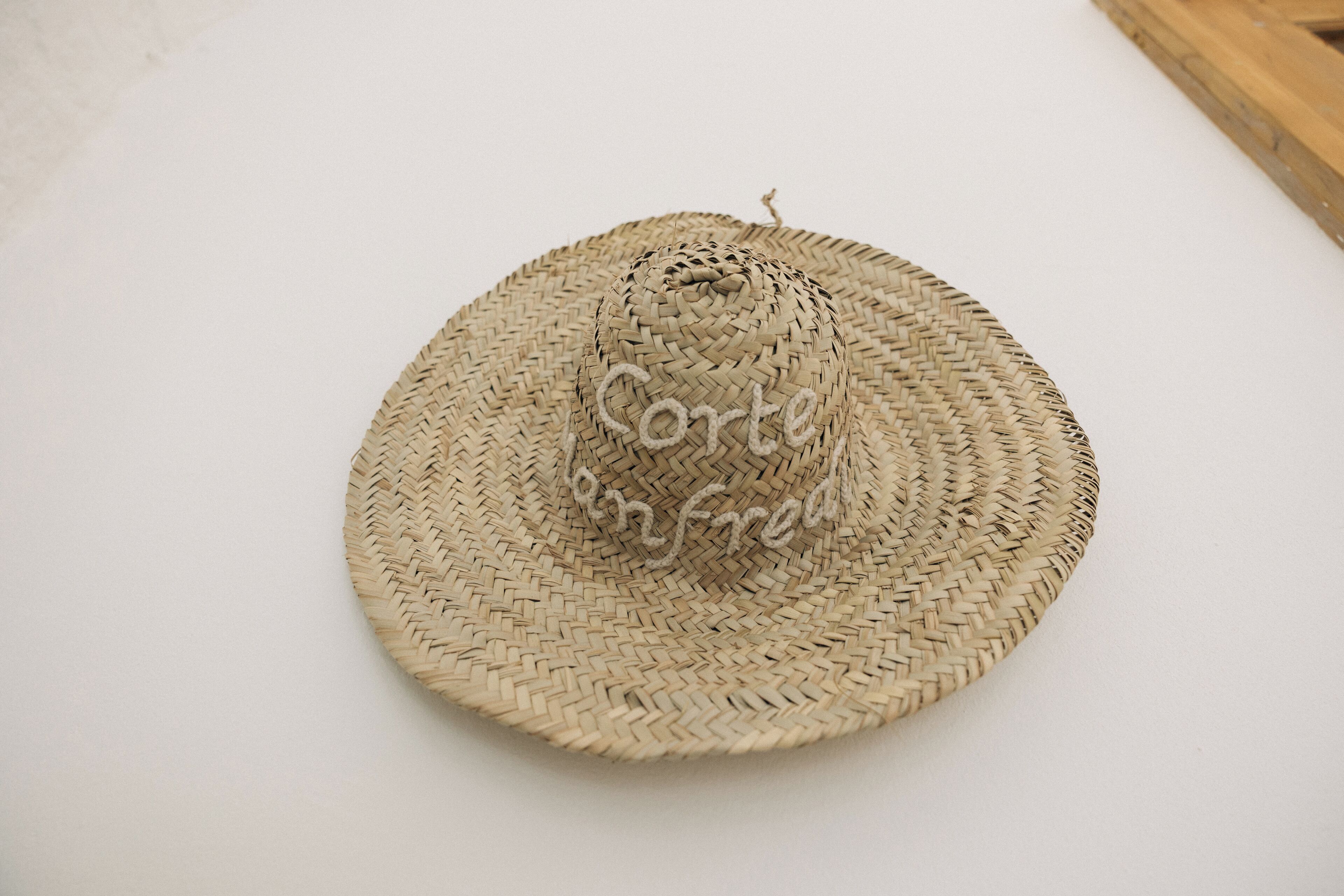 A woven straw hat with a label on it.