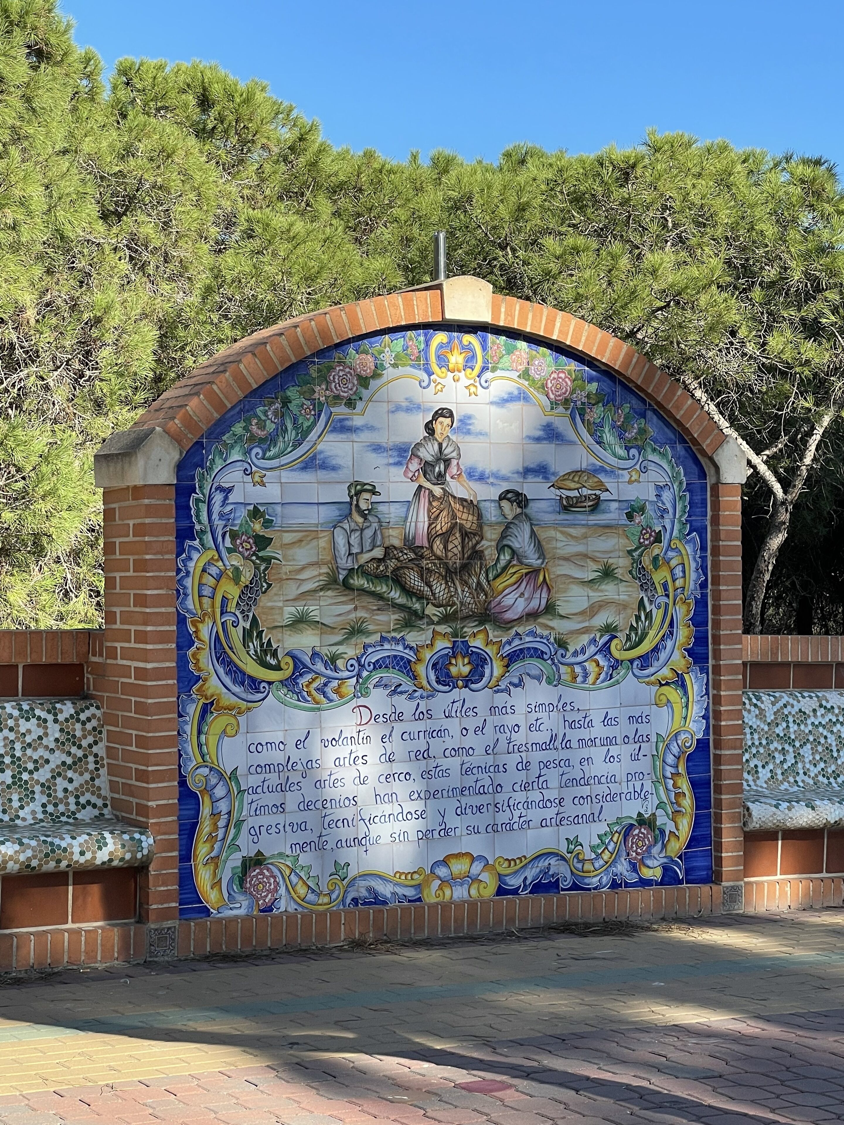 A mural with a tiled archway, featuring a scene with people and decorative elements.