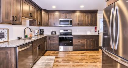 Updated, tree-lined home on the snowmobile trail with gas fireplace & firepit