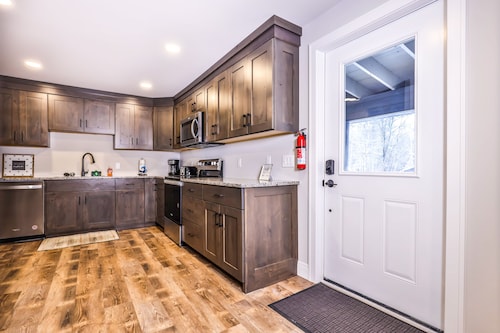 Updated, tree-lined home on the snowmobile trail with gas fireplace & firepit