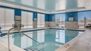 A pool area with clear signage indicating no lifeguard on duty and no diving.
