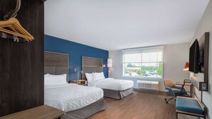 A hotel room with two beds, a desk, a chair, a TV, and a window with a view of the outside. - Tru By Hilton Fayetteville Fort Bragg (Fayetteville)