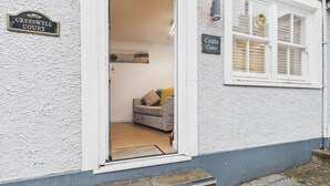 A white building with a sign reading 'Cresswell Court' and another sign 'Castle Cove.' - Castle Cove - 1 Bedroom Apartment - Tenby (Tenby)