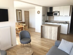 Eine moderne Wohnung mit Küche, Essbereich und Wohnzimmer.
