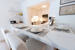 Enjoy a comfortable dining experience in this well-appointed space with a long dining table and plush chairs.
