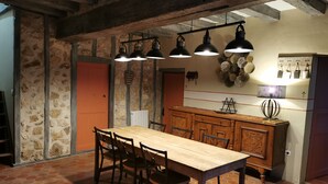 A rustic dining area with a wooden table and chairs, stone walls, and exposed beams. - Le clos verdonnais  (Verdon)