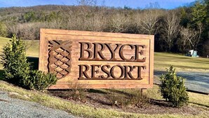 A wooden sign for Bryce Resort with a pine tree design. - Spacious & Secluded Mountain Retreat by Bryce Resort: Ski, Mtn Bike, Game room (Basye)