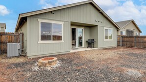 A single-story house with a covered patio, a fire pit, and a grill area. - Ski, Hike & Explore: Bellemont Home w/ Fenced Yard (Bellemont)