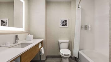 A modern bathroom with a white sink, a toilet, and a bathtub.