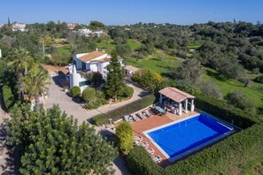 A large house with a swimming pool, surrounded by lush greenery and a hilly landscape. - Casa Josephine by Portucasa (Olhao)