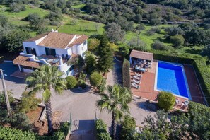 A modern villa with a swimming pool, surrounded by lush greenery and a well-maintained garden. - Casa Josephine by Portucasa (Olhao)